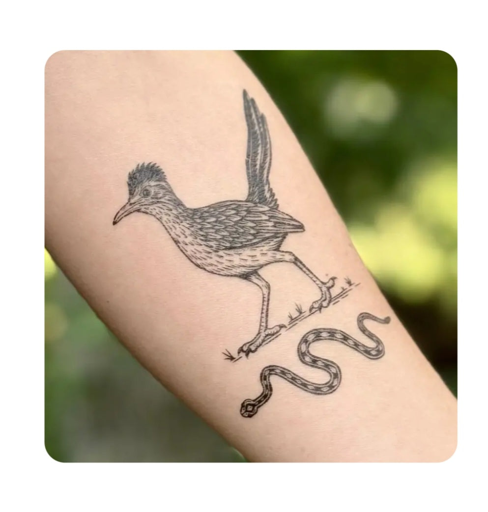 Temporary tattoo of a road runner and snake on an arm, black ink design