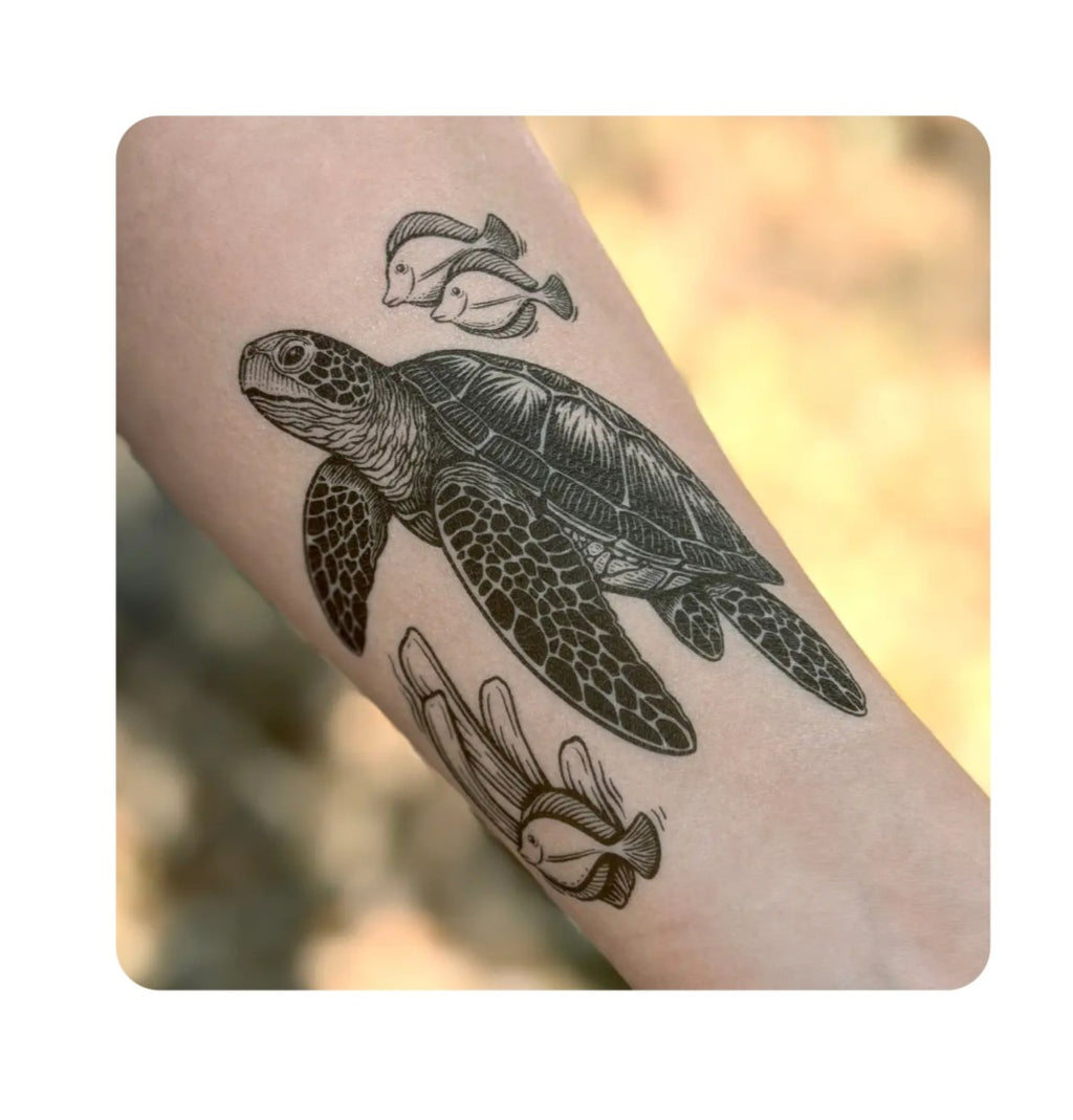 Sea turtle temporary tattoo on bare skin, black and gray line art