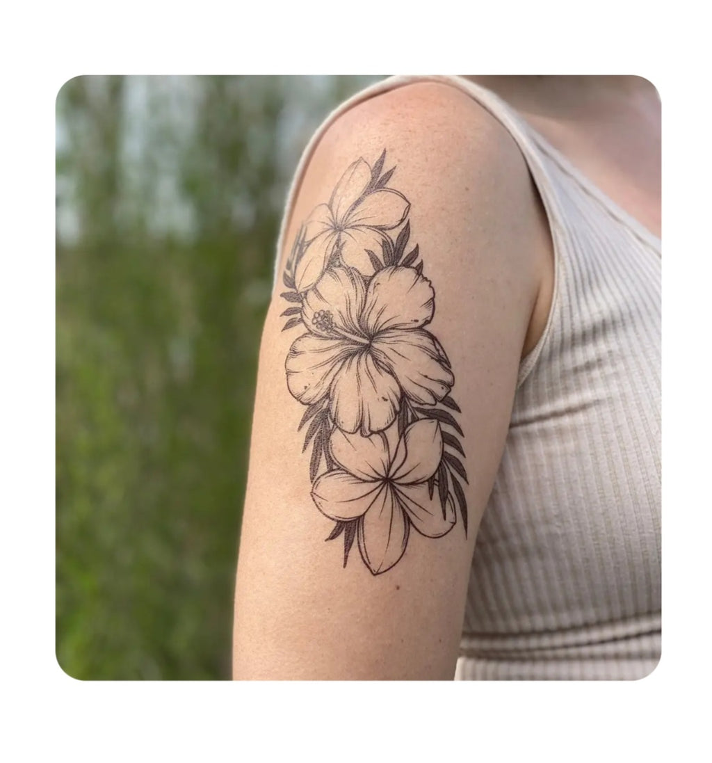 Tropical floral temporary tattoo, black flower and leaf outline on forearm