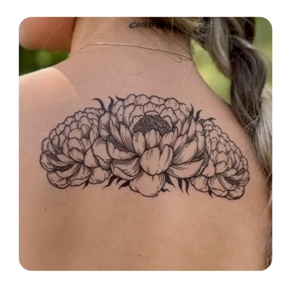 Black peony flower temporary tattoo on upper back skin