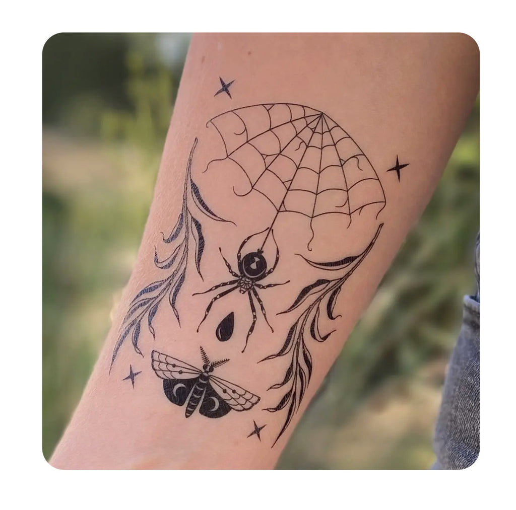 Temporary tattoo on forearm, spiderweb dreamcatcher design with star accents