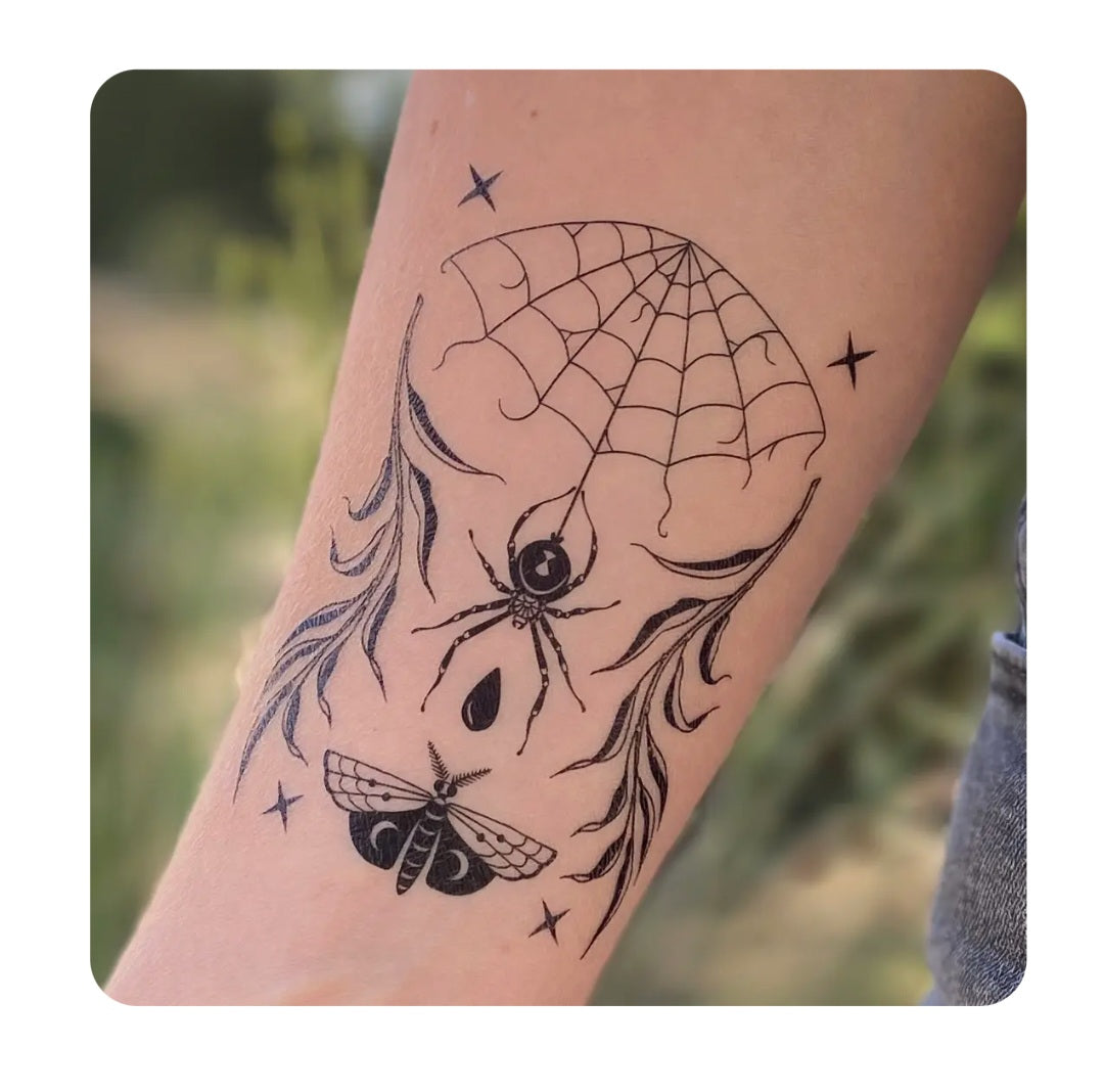 Temporary tattoo on forearm, spiderweb dreamcatcher design with star accents
