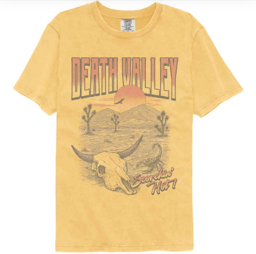 Yellow crewneck t-shirt with Death Valley graphic, cow skull and desert scene