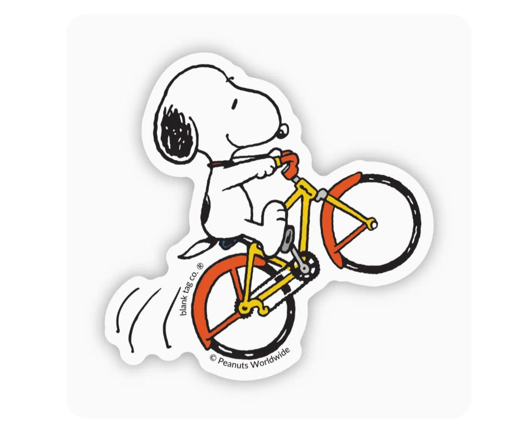 Waterproof Peanuts sticker of Snoopy riding an orange wheelie bicycle