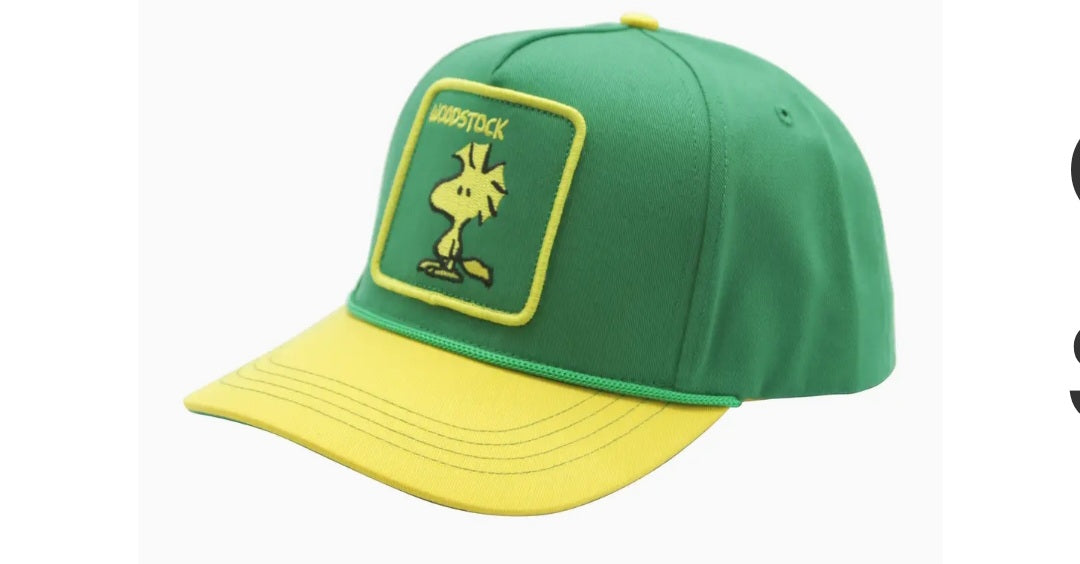 Green baseball cap with yellow brim and front character patch, adjustable strap
